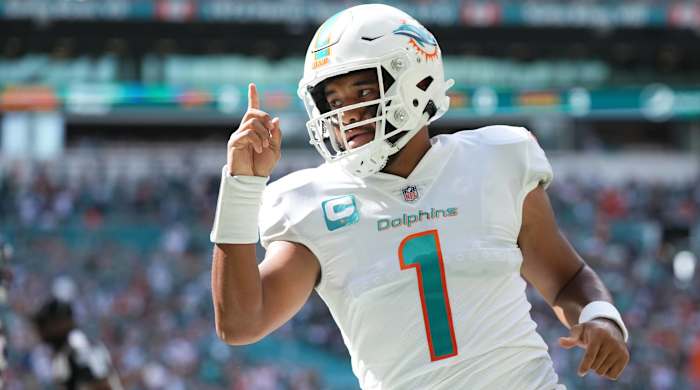 Dolphins quarterback Tua Tagovailoa celebrates a touchdown in a game.